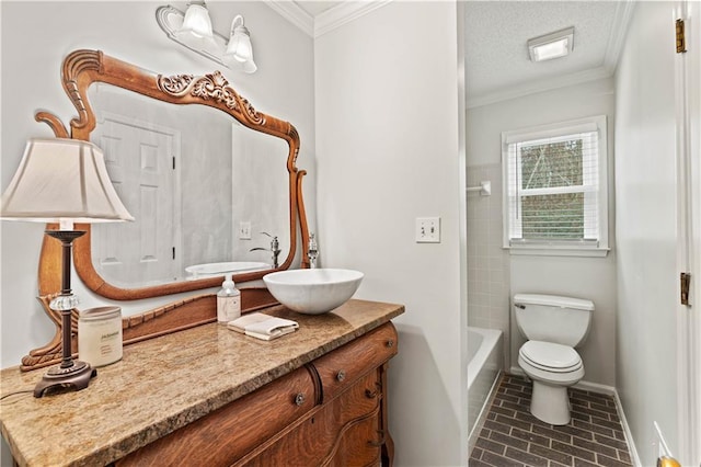 full bath with baseboards, toilet, vanity, a textured ceiling, and crown molding