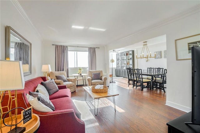 living room featuring hardwood / wood-style floors, a notable chandelier, and crown molding