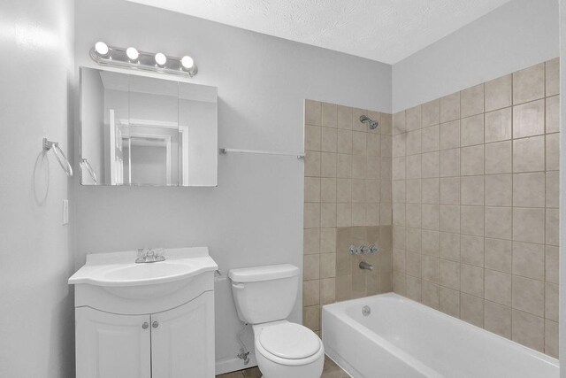 3618 Mansfield Ln, Snellville, GA 30039 - full bathroom with shower / tub combination, toilet, vanity, and a textured ceiling