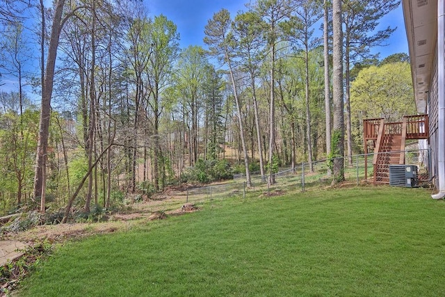 3618 Mansfield Ln, Snellville, GA 30039 - view of yard featuring central air condition unit, a view of trees, and fence