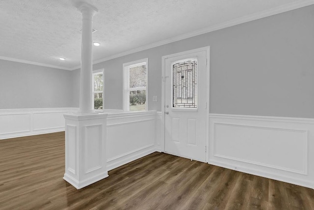 3618 Mansfield Ln, Snellville, GA 30039 - interior space with decorative columns, ornamental molding, dark wood-style floors, and a textured ceiling