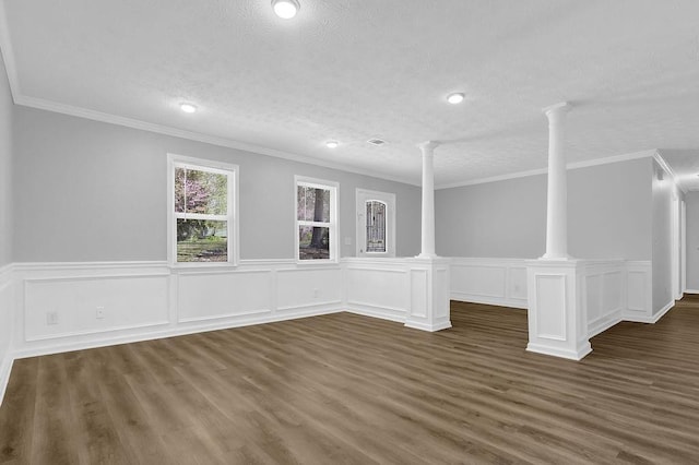 3618 Mansfield Ln, Snellville, GA 30039 - empty room featuring decorative columns, dark wood-style flooring, crown molding, and a textured ceiling