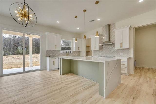 4265 Haynes Cir, Snellville, GA 30039 - hallway with a notable chandelier and light wood-type flooring