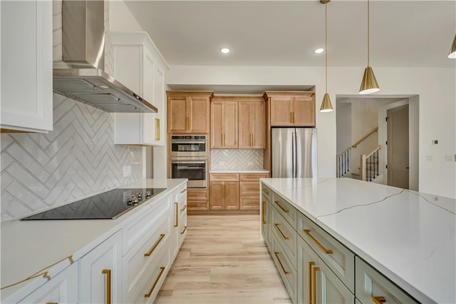 4265 Haynes Cir, Snellville, GA 30039 - kitchen featuring wall chimney range hood, stainless steel appliances, a center island, and white cabinets