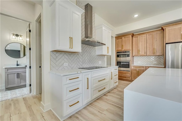 4265 Haynes Cir, Snellville, GA 30039 - kitchen featuring dishwasher, sink, white cabinets, black electric stovetop, and wall chimney range hood