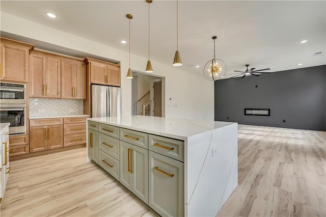 4265 Haynes Cir, Snellville, GA 30039 - kitchen with sink, tasteful backsplash, a center island, pendant lighting, and light stone countertops