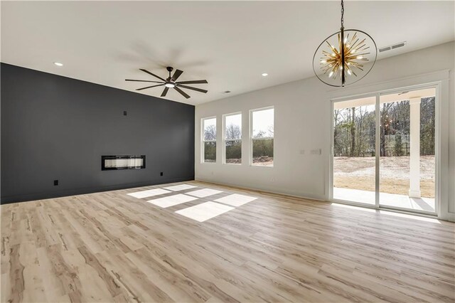4265 Haynes Cir, Snellville, GA 30039 - kitchen featuring a large island, appliances with stainless steel finishes, hanging light fixtures, backsplash, and light hardwood / wood-style floors