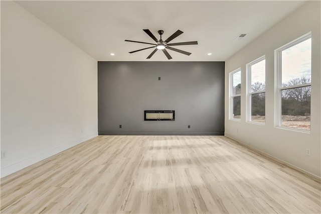 4265 Haynes Cir, Snellville, GA 30039 - unfurnished living room featuring ceiling fan with notable chandelier and light wood-type flooring