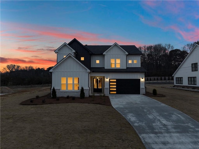 modern farmhouse style home with a garage and a lawn