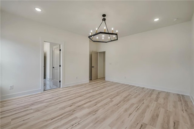 4265 Haynes Cir, Snellville, GA 30039 - empty room featuring an inviting chandelier and light hardwood / wood-style flooring