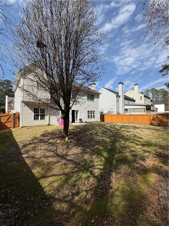 rear view of property featuring fence