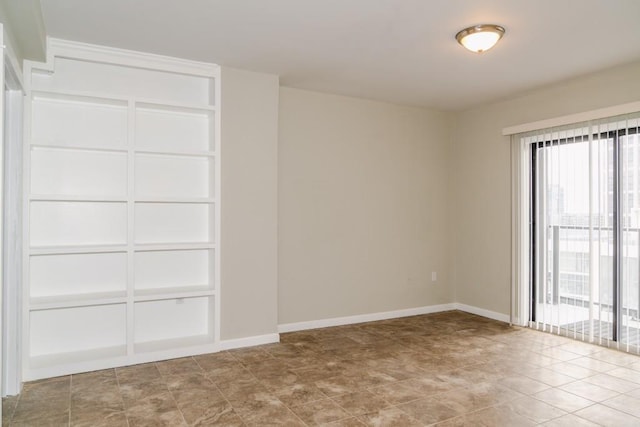 empty room featuring baseboards