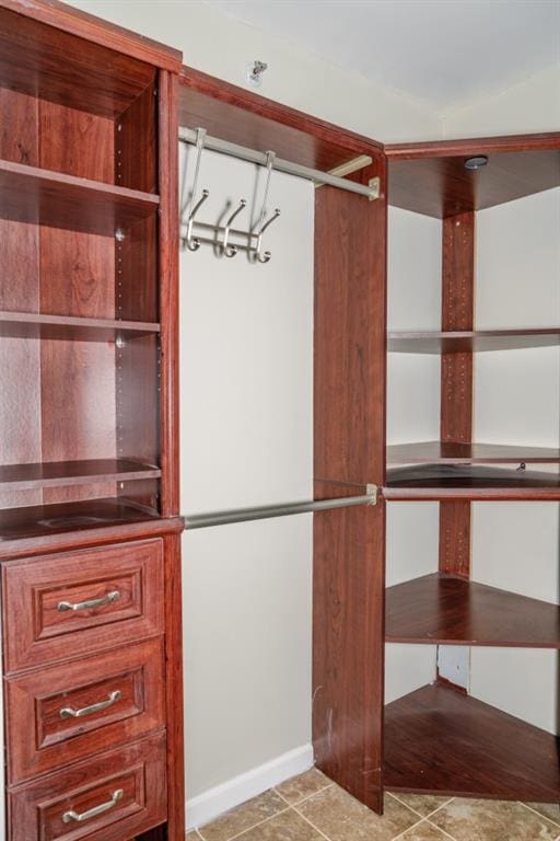 walk in closet with tile patterned floors