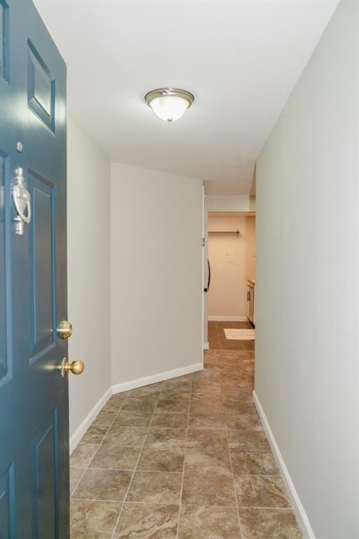 hallway featuring baseboards