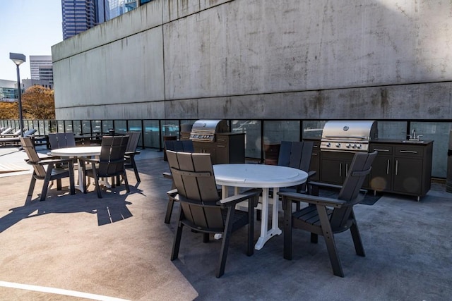 view of patio / terrace featuring outdoor dining space, area for grilling, and a grill