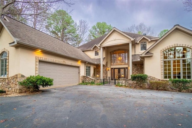 front of property featuring a garage and french doors