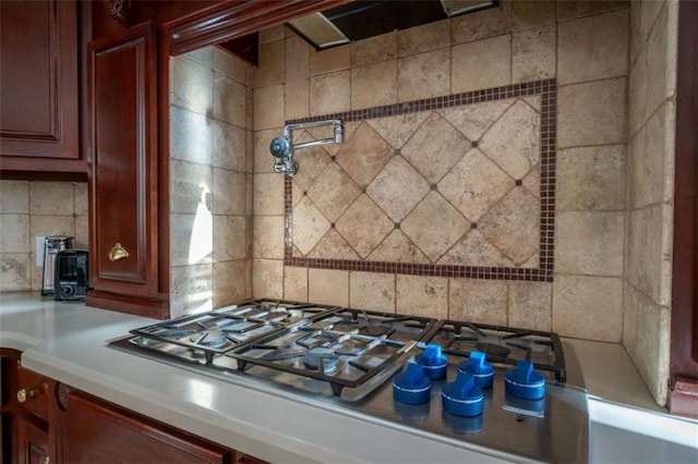 kitchen featuring stainless steel gas stovetop and backsplash