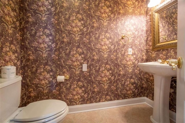 bathroom with tile patterned flooring, toilet, and sink