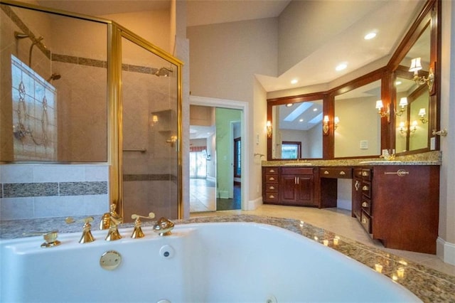 bathroom featuring separate shower and tub and vanity