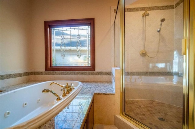 bathroom featuring shower with separate bathtub