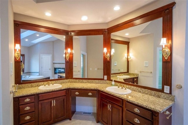 bathroom with vanity and a tub