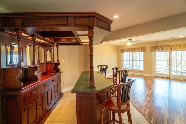 interior space with ceiling fan and light tile patterned floors