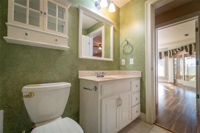 bathroom with tile patterned flooring, vanity, and toilet