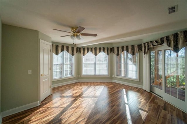 unfurnished dining area with hardwood / wood-style flooring and ceiling fan