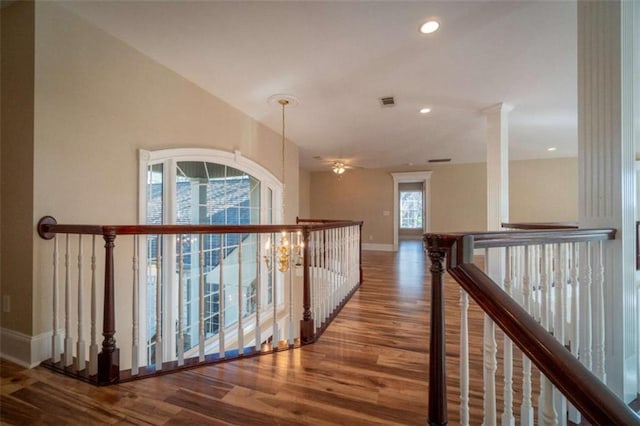 corridor featuring hardwood / wood-style flooring and a notable chandelier