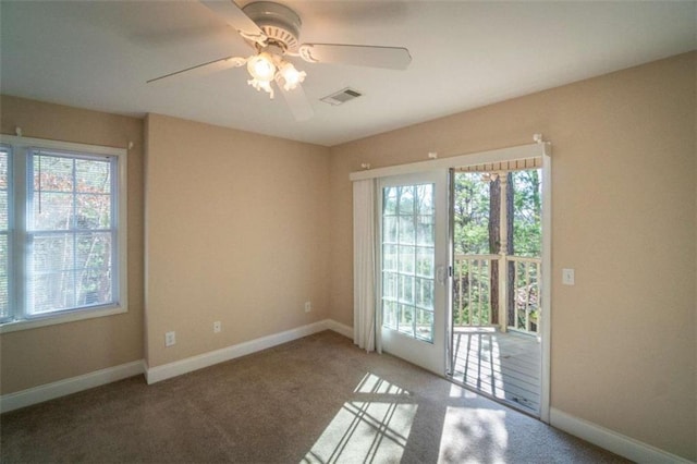 carpeted empty room featuring ceiling fan