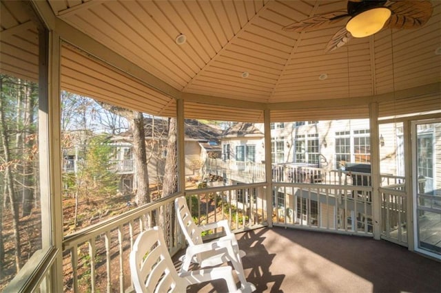 sunroom with a wealth of natural light, ceiling fan, wooden ceiling, and vaulted ceiling