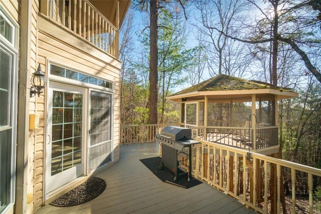 wooden terrace with a gazebo and grilling area