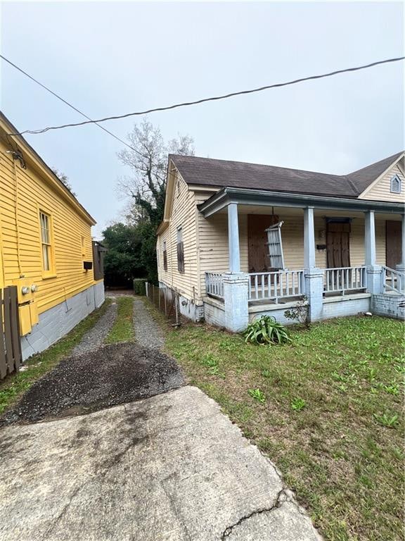 view of side of home with covered porch