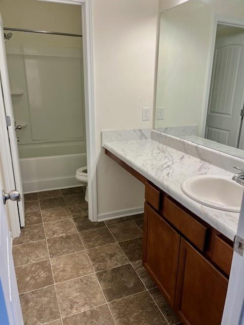 full bathroom with vanity, shower / bath combination, and toilet