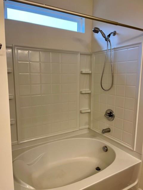 bathroom with washtub / shower combination