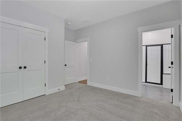 unfurnished bedroom featuring light colored carpet