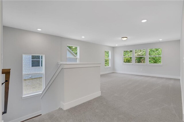 spare room featuring light colored carpet