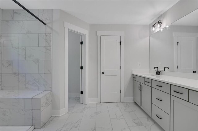 bathroom featuring vanity and tiled shower