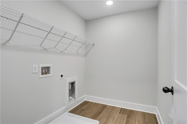 washroom featuring washer hookup, hookup for an electric dryer, and hardwood / wood-style flooring