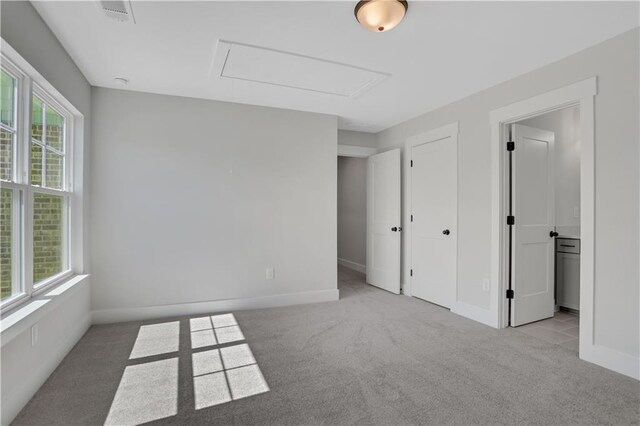 carpeted spare room featuring plenty of natural light