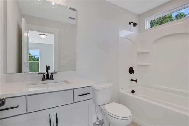 full bathroom with bathing tub / shower combination, vanity, and toilet