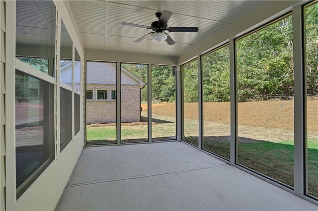 unfurnished sunroom featuring ceiling fan