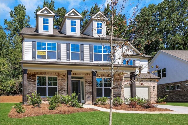 view of front of home featuring a front yard and a garage