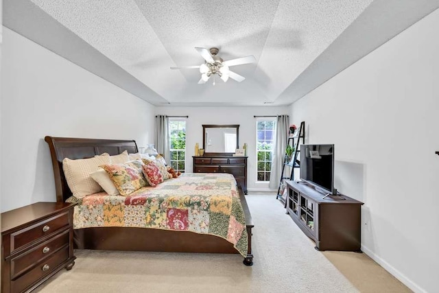 835 Custom Ln, Winder, GA 30680 - bedroom with a tray ceiling, light carpet, a textured ceiling, ceiling fan, and baseboards