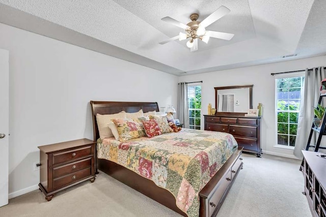 835 Custom Ln, Winder, GA 30680 - bedroom with light carpet, a raised ceiling, a textured ceiling, baseboards, and a ceiling fan