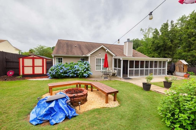 835 Custom Ln, Winder, GA 30680 - rear view of house featuring an outdoor fire pit, a sunroom, a chimney, and a patio area
