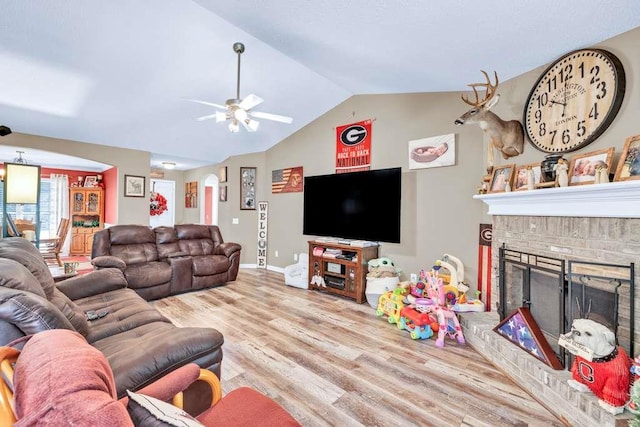 835 Custom Ln, Winder, GA 30680 - living area featuring wood finished floors, vaulted ceiling, ceiling fan, a brick fireplace, and baseboards