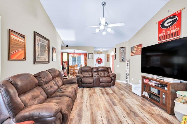 835 Custom Ln, Winder, GA 30680 - living room with vaulted ceiling, light wood-style flooring, ceiling fan, a chandelier, and baseboards
