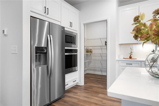 kitchen featuring white cabinets, dark hardwood / wood-style flooring, and stainless steel appliances