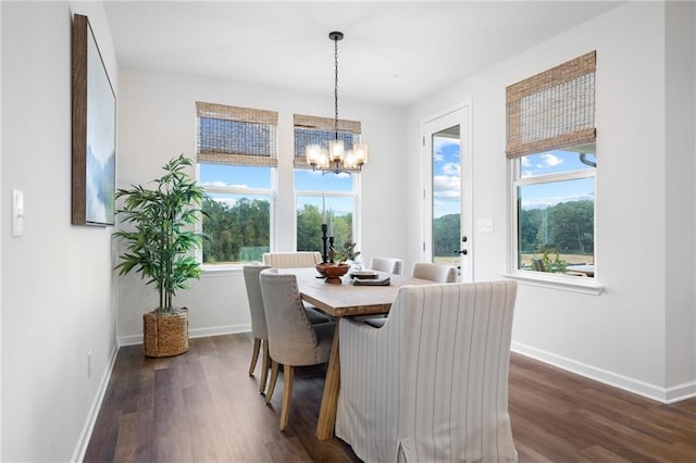 dining room featuring dark wood-type flooring and a notable chandelier